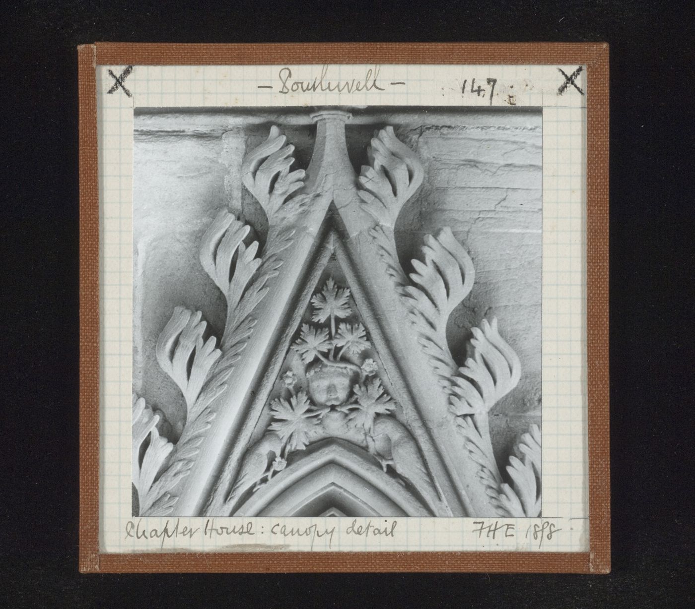 Detail view of canopy with foliate mask and two birds on tympanum in Chapter House, Southwell Minster, Southwell, Nottinghamshire, England