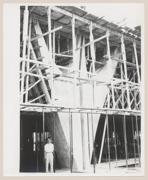 View of Governor Juscelino Kubitschek's Complex, under construction, with man standing under scaffolding, Belo Horizonte, Brazil
