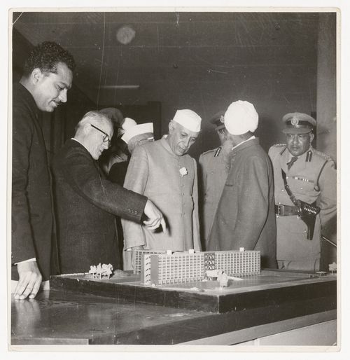 Photograph of Prime Minister Jawaharlal Nehru, Pierre Jeanneret, Jeet Lal Malhotra, and others, looking at a model