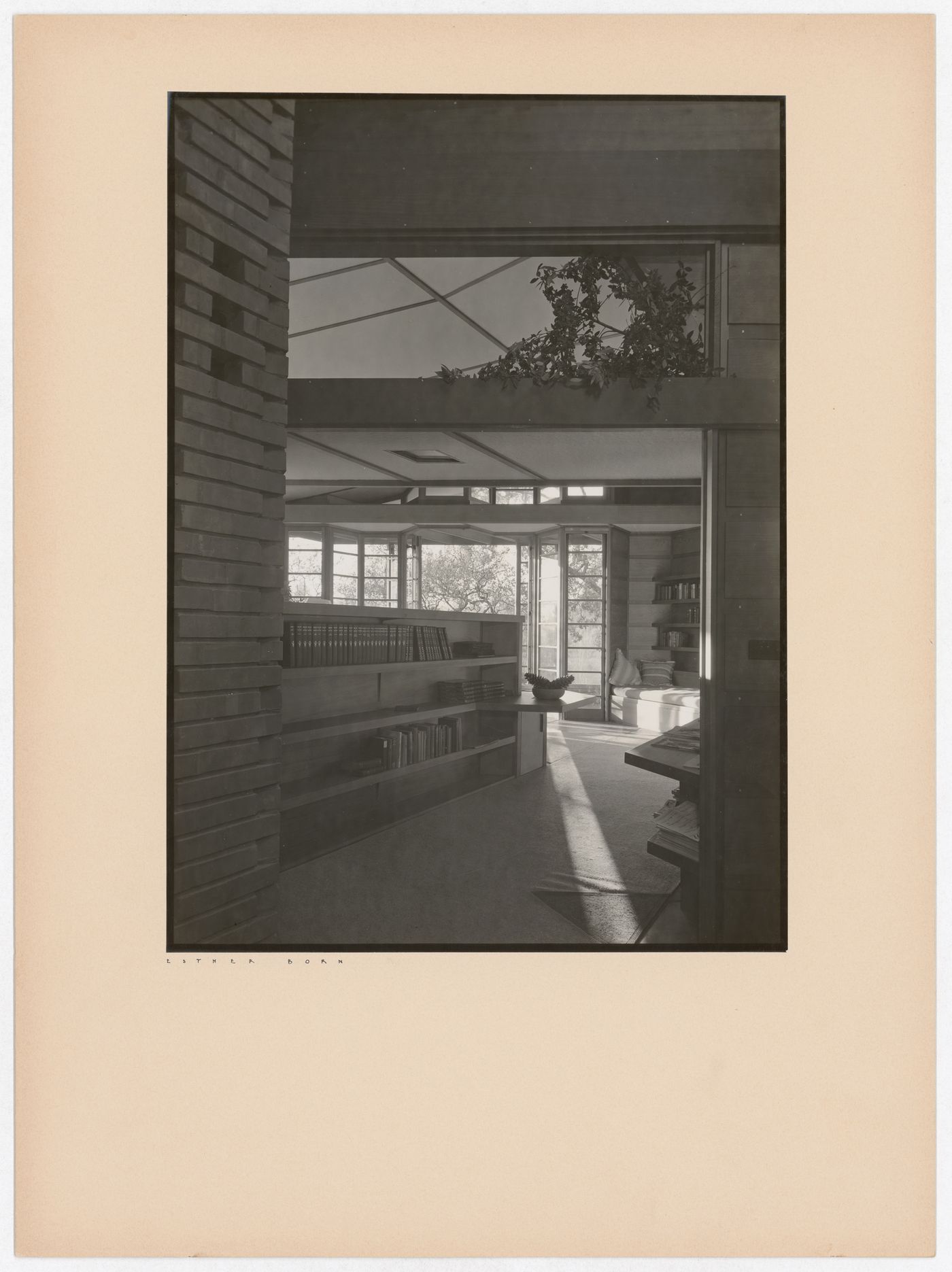 Interior view of the Hanna House showing a doorway, windows, bookshelves, tables, and seating furniture, Palo Alto, California, United States