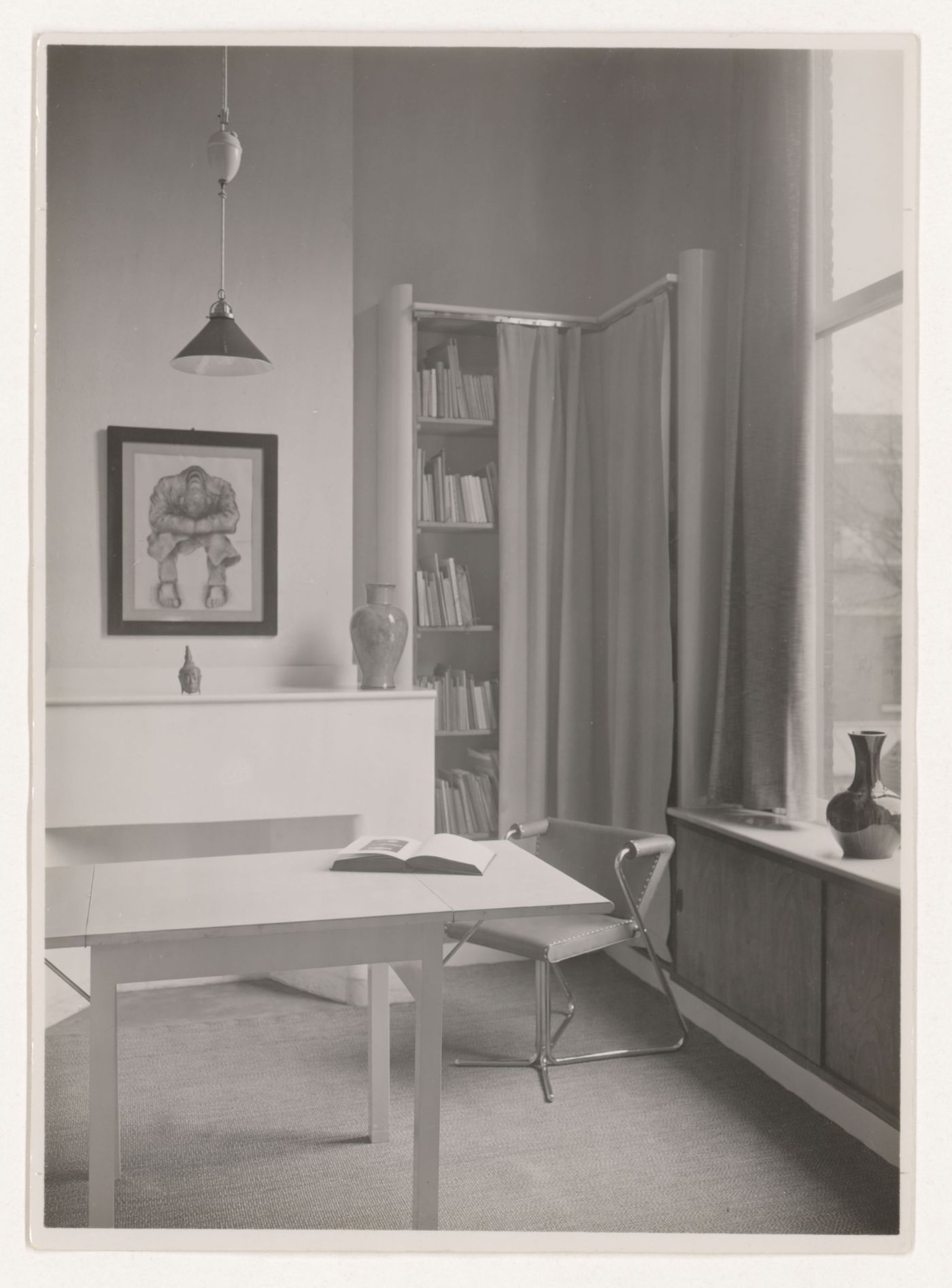 Interior view of the study of Hannema House I showing an elbow chair designed by J.J.P. Oud, a dropleaf table and curtained bookshelves, Rotterdam, Netherlands