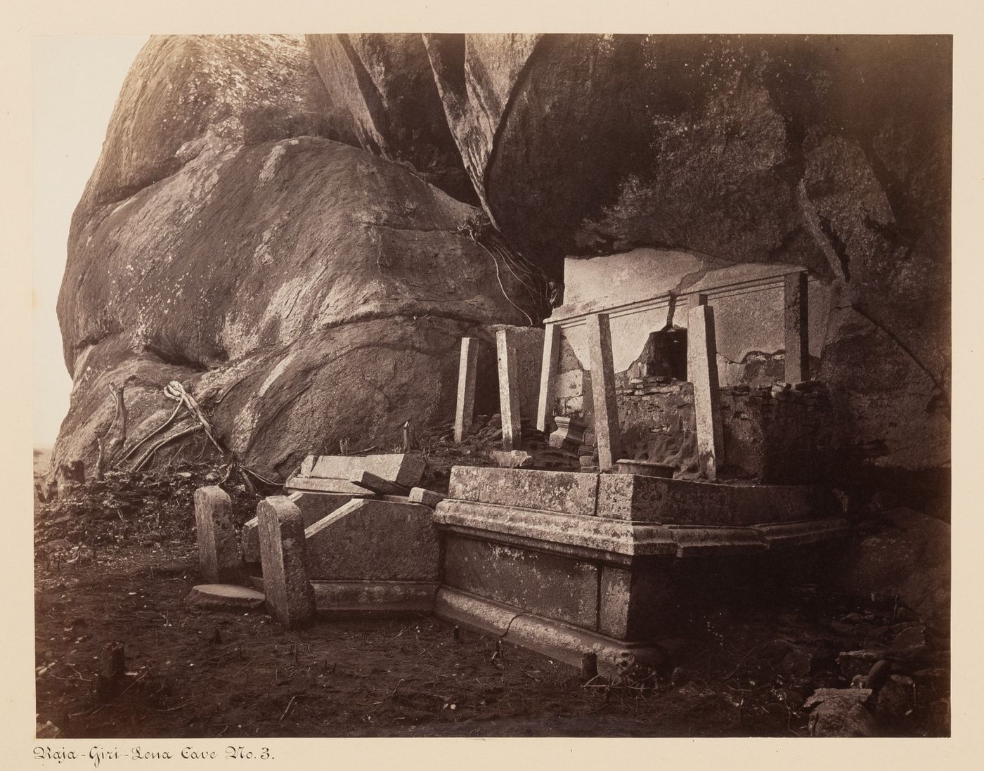 View of the ruins of a cave temple [?], possibly known as Cave No. 3, Raja-Giri-Lena (also known as Raja-Giri-Lena-Kande and Care Mountain), Mihintale, Ceylon (now Sri Lanka)