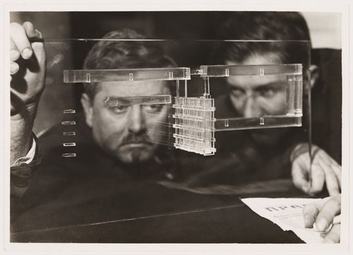 Portrait of D. Fridman and G. Glushchenko through a glass model for the Building of Industry, Sverdlovsk, Soviet Union (now Ekaterinburg, Russia)