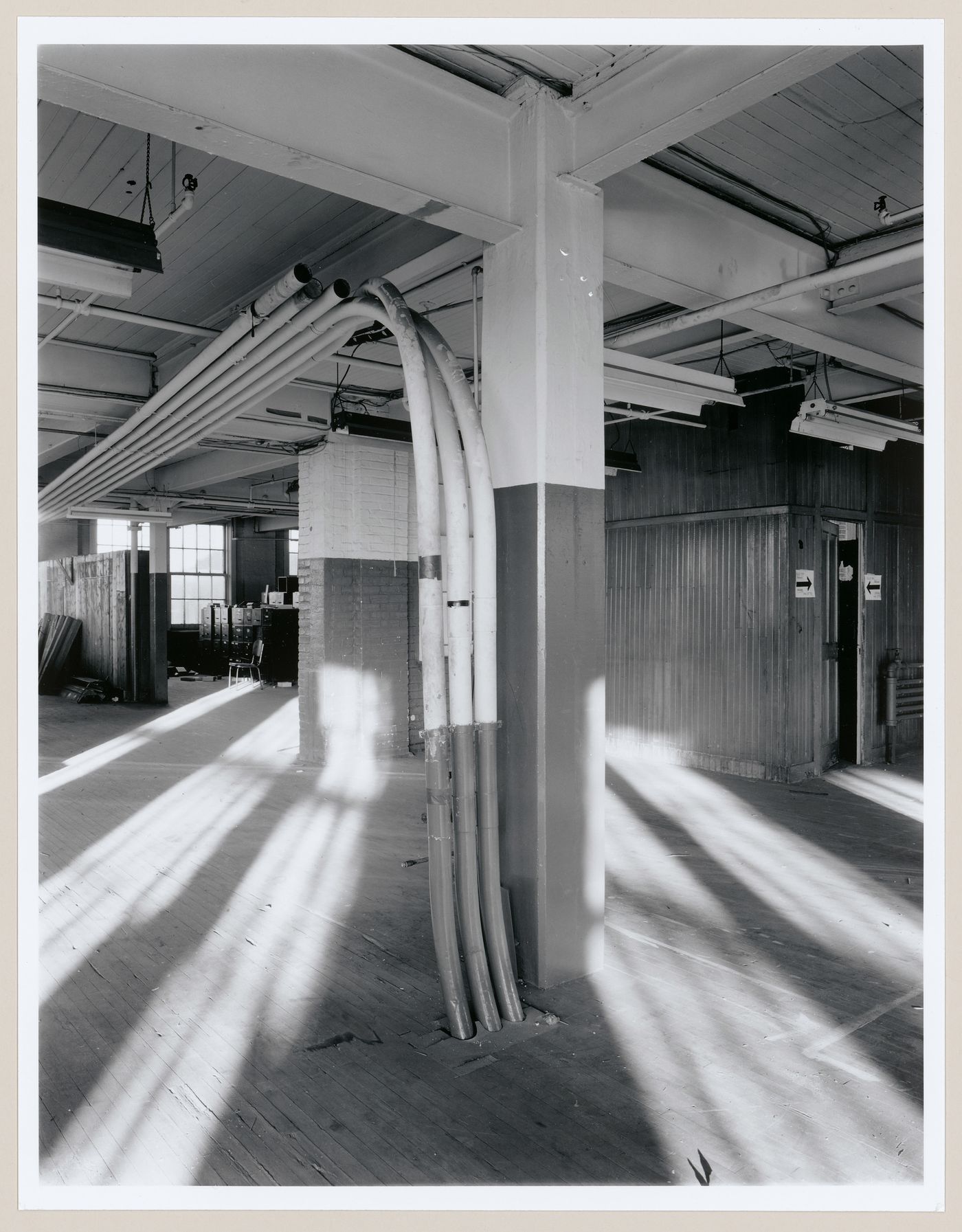 Interior view of an office area on the third floor of the administration building of the Belding Corticelli Spinning Mill showing pneumatic dispatch tubes, Montréal, Québec