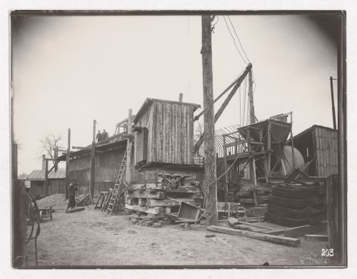 Construction of the Paris Metro, exterior view with wooden buildings and workers, Paris, France