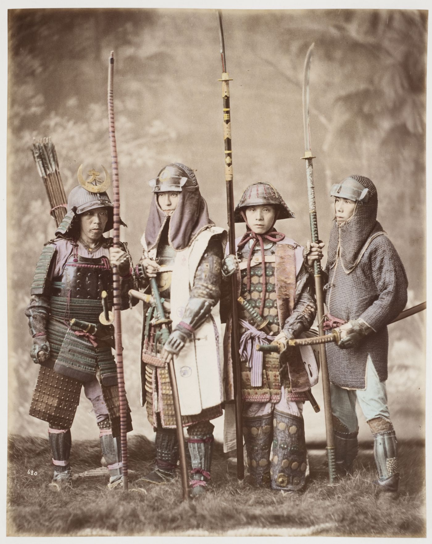 Group portrait of four samurai wearing armour and holding various weapons, Japan