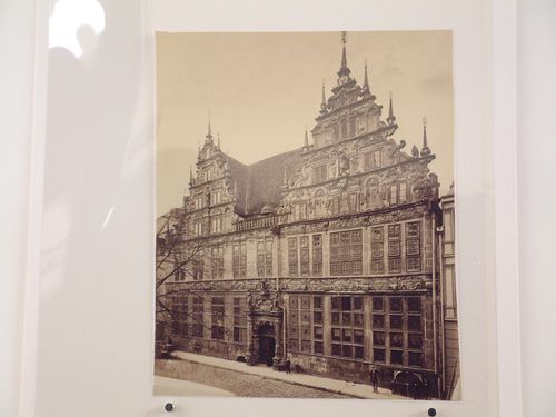 View of façade of highly ornate 5 storey, gabled house facing cobblestoned street, Germany ?