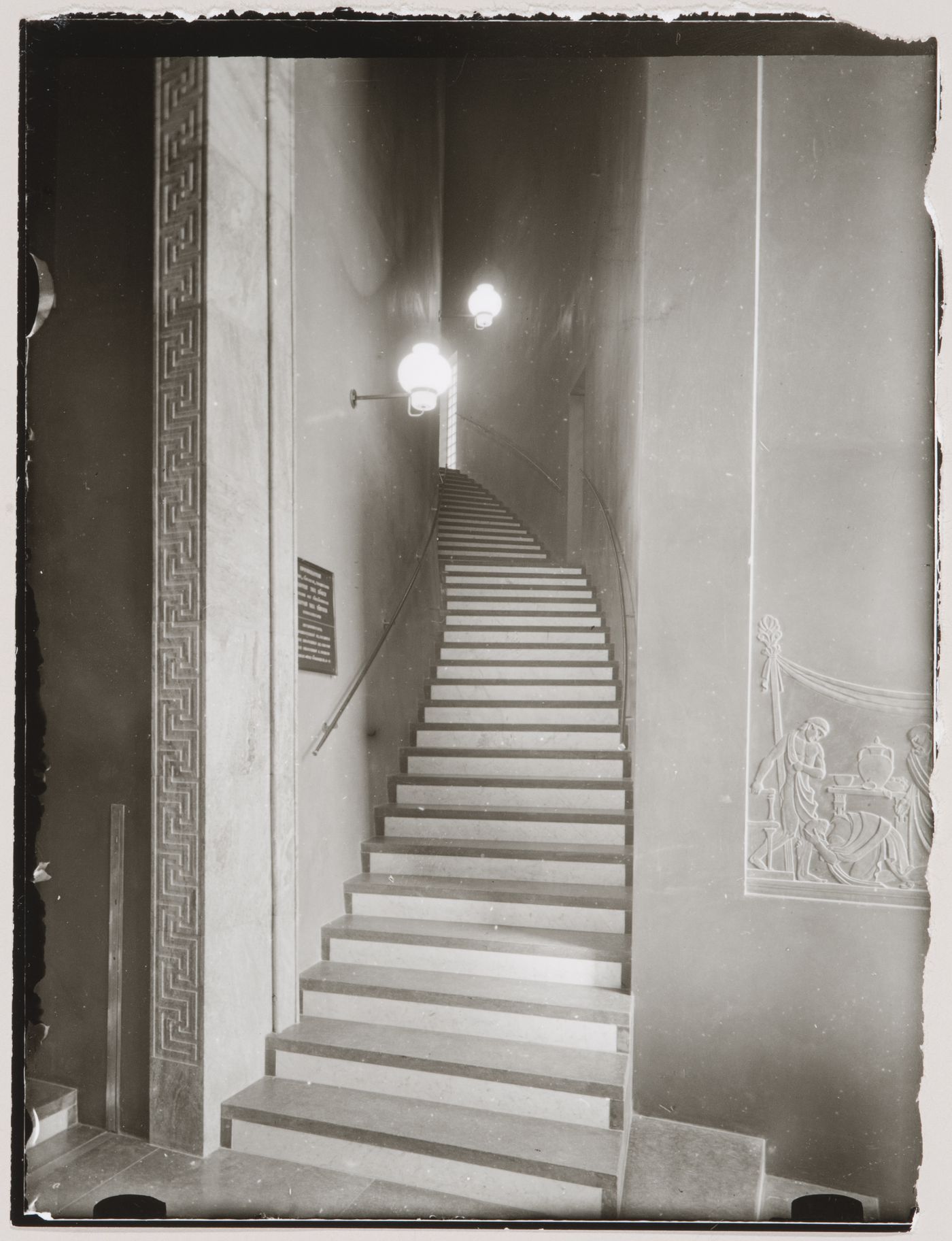 Interior view of the lobby of Stockholm Public Library showing the side stairs leading to the lending hall and a bas-relief depicting a scene from the Iliad sculpted by Ivar Viktor Johnsson, 51-55 Odengatan, Stockholm