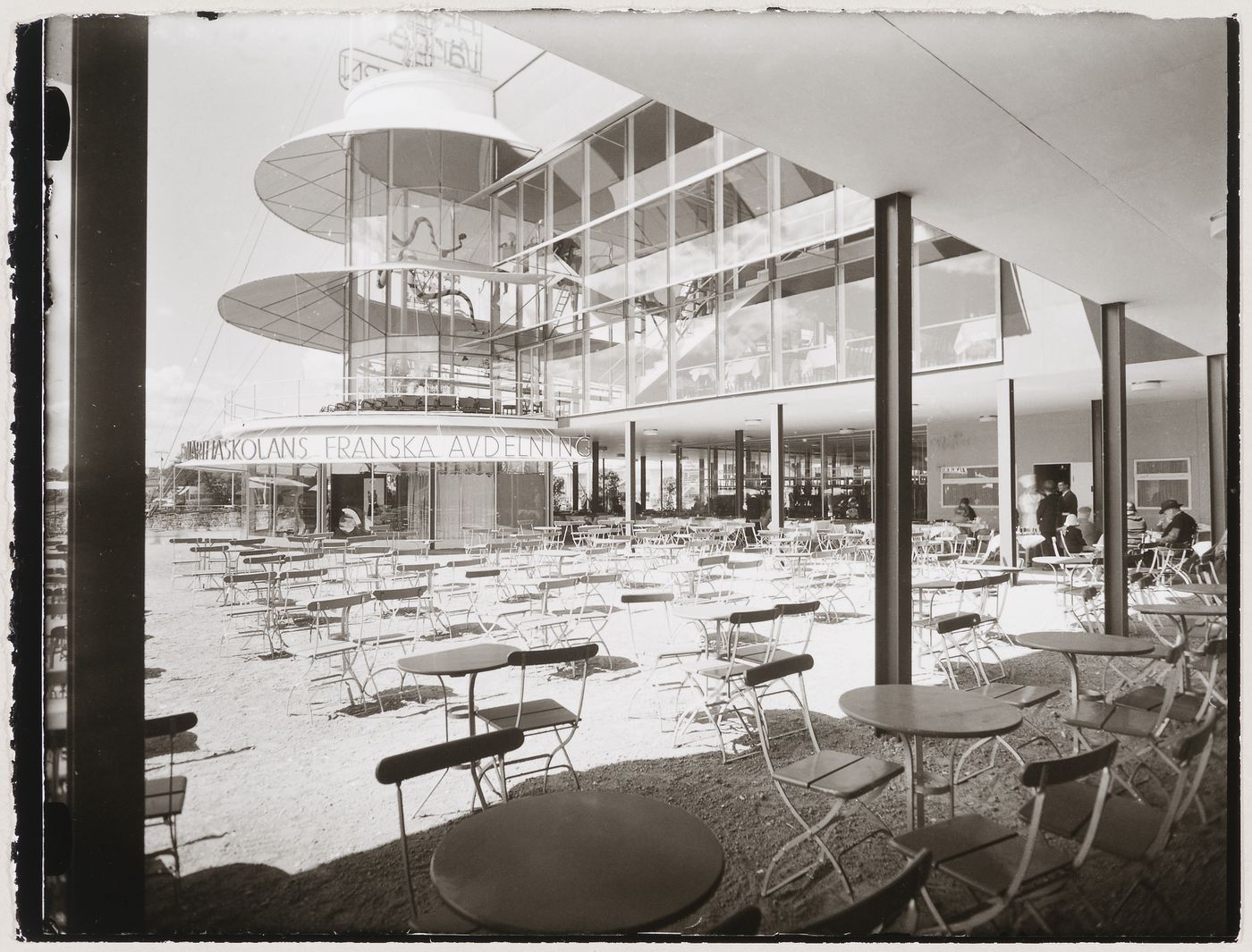 View of the lateral façade of Paradise Restaurant at the Stockholm Exhibition of 1930 showing the terrace with tables and chairs, Stockholm