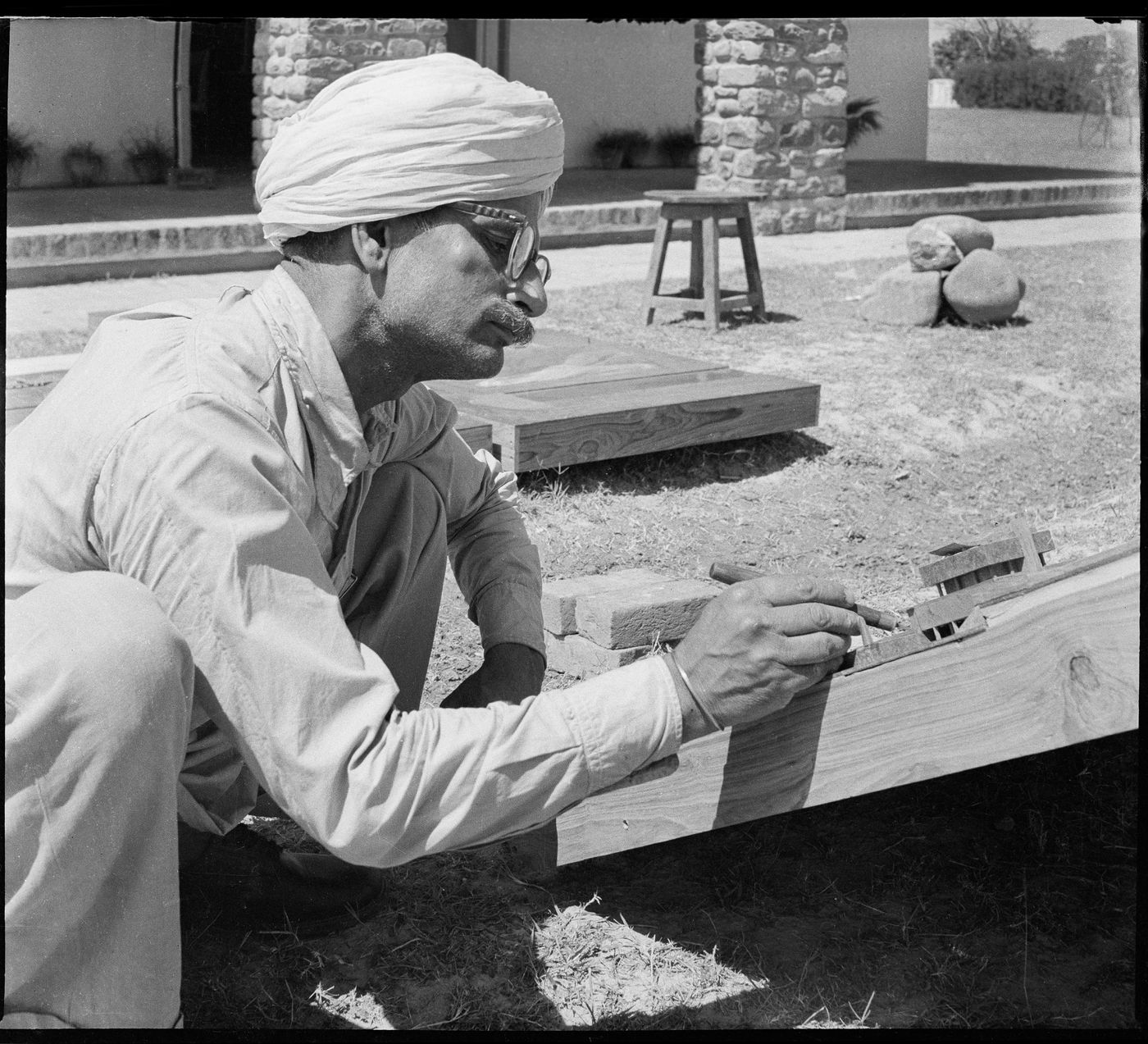 Model maker working on a component of a model for the Capitol Complex, Chandigarh, India