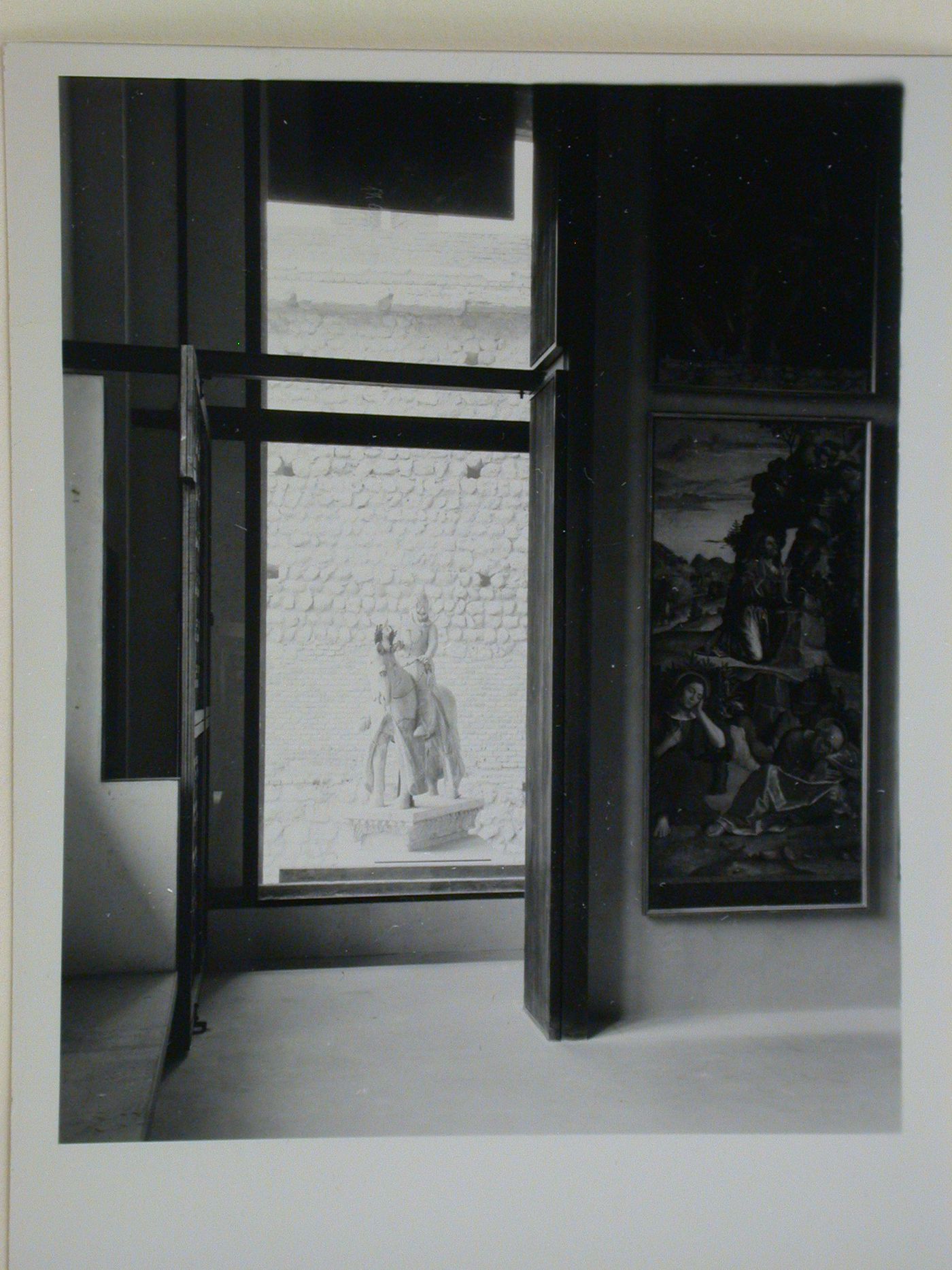 Interior view of a gallery showing paintings with the Can Grande della Scala Statue in the background, Museo di Castelvecchio, Verona, Italy