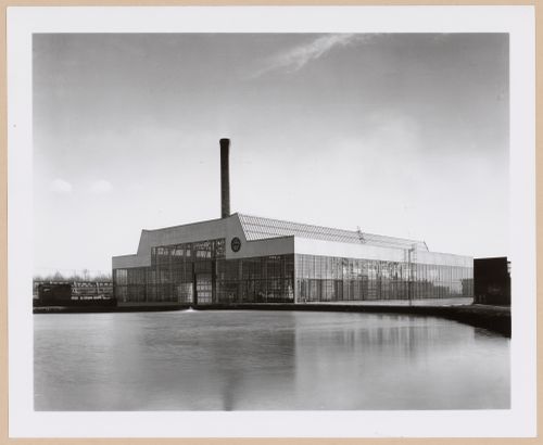 General view of the principal [?] and lateral façades of the Roll and Heavy Machine Shop from across a river [?], Ohio Steel Foundry, Lima, Ohio