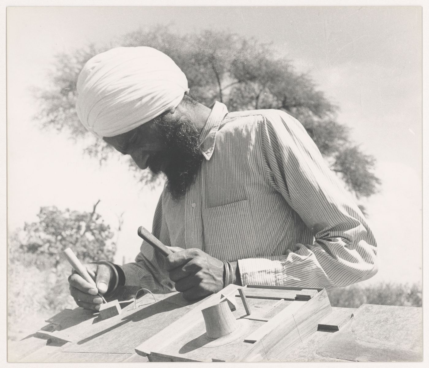 Portrait of the model maker, Rattan Singh, at work on the model for Capitol Complex, Sector 1, Chandigarh, India