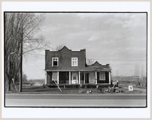 View of a house showing a garage sale, Saint-Hubert, Québec