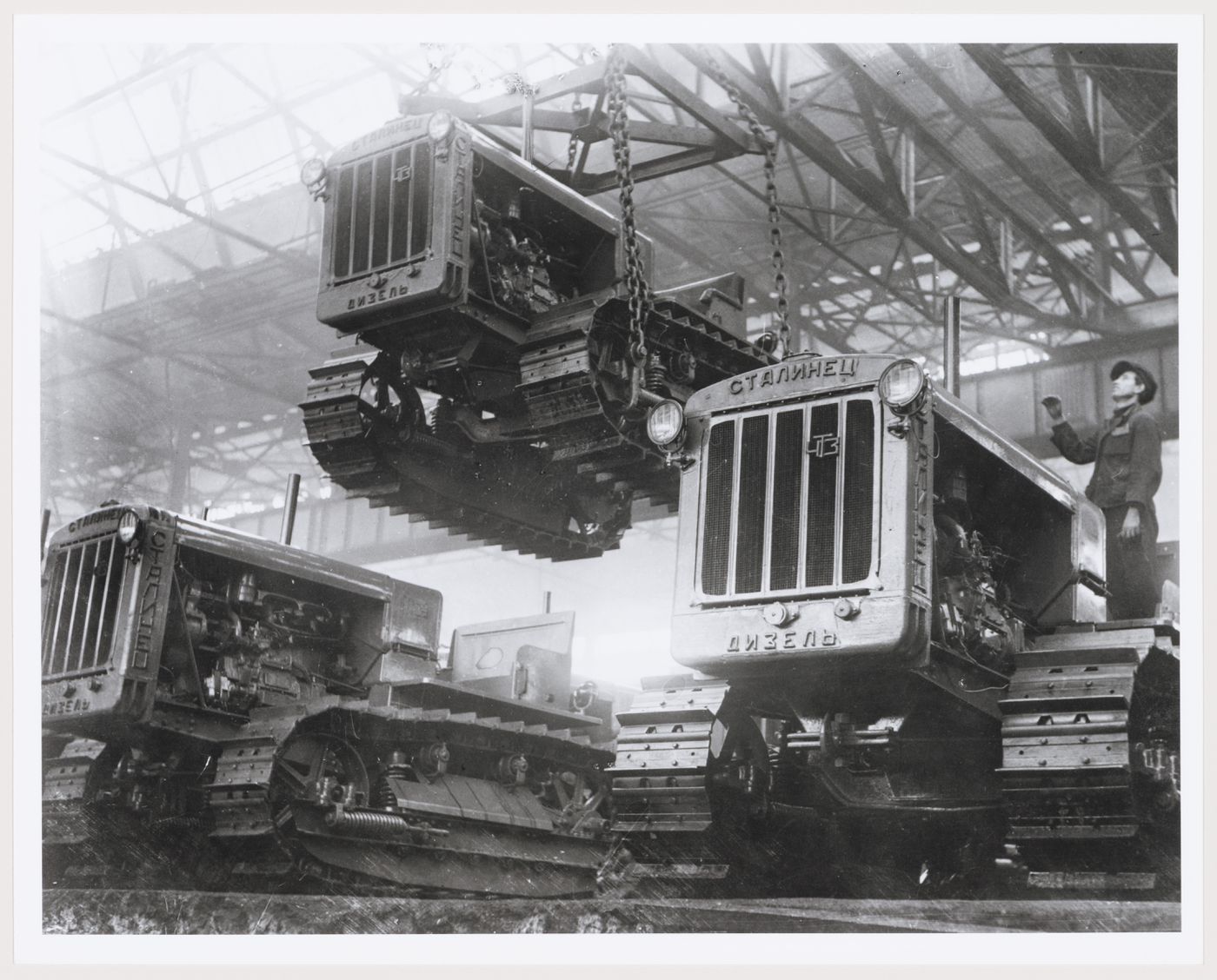 Interior view of the Assembly [?] Building showing tractors, Soviet Diesel Tractor Assembly Plant, Cheliabinsk, Soviet Union (now in Russia)