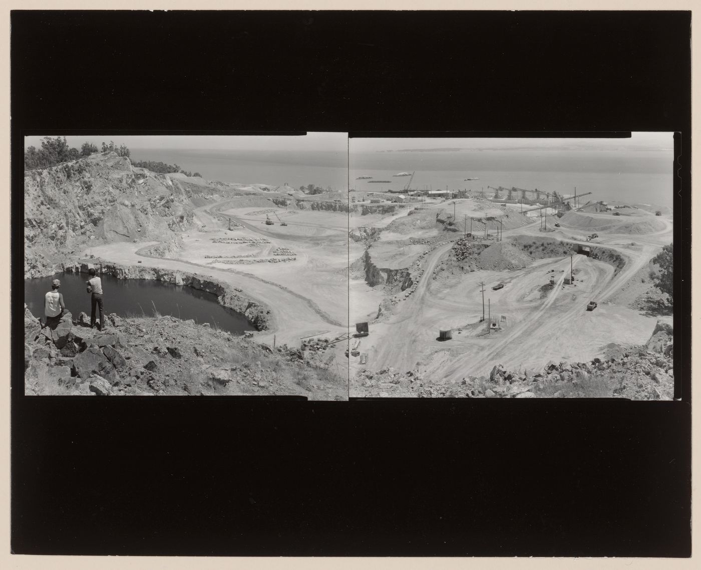 Panoramic composite photograph of the San Rafael Rock Quarry showing pits, trucks, machinery, and a lake with San Francisco Bay in the distance, Point San Pedro, San Rafael, Marin County, California, United States
