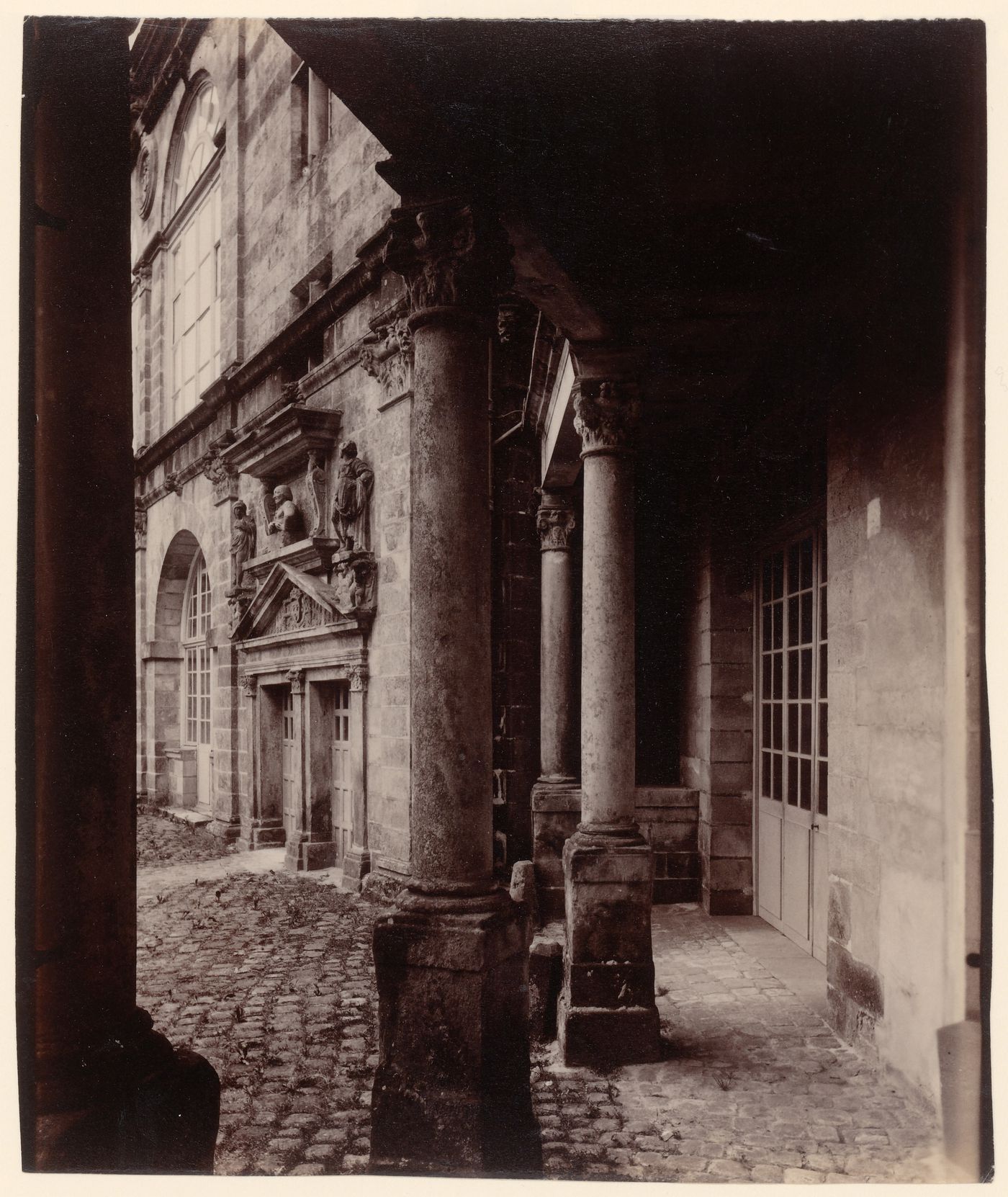 Interior view of a portico showing columns and a façade, Cour Ovale, Château de Fontainebleau, Fontainebleau, France