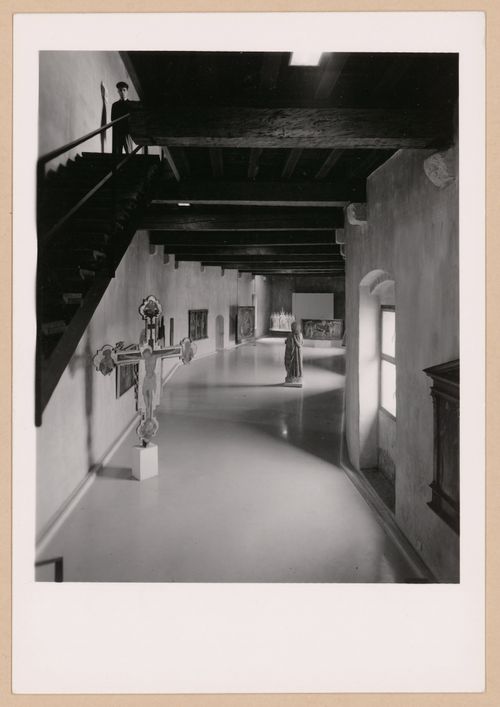 Interior view of a gallery showing a freestanding painted crucifix, a statue and paintings, Museo di Castelvecchio, Verona, Italy