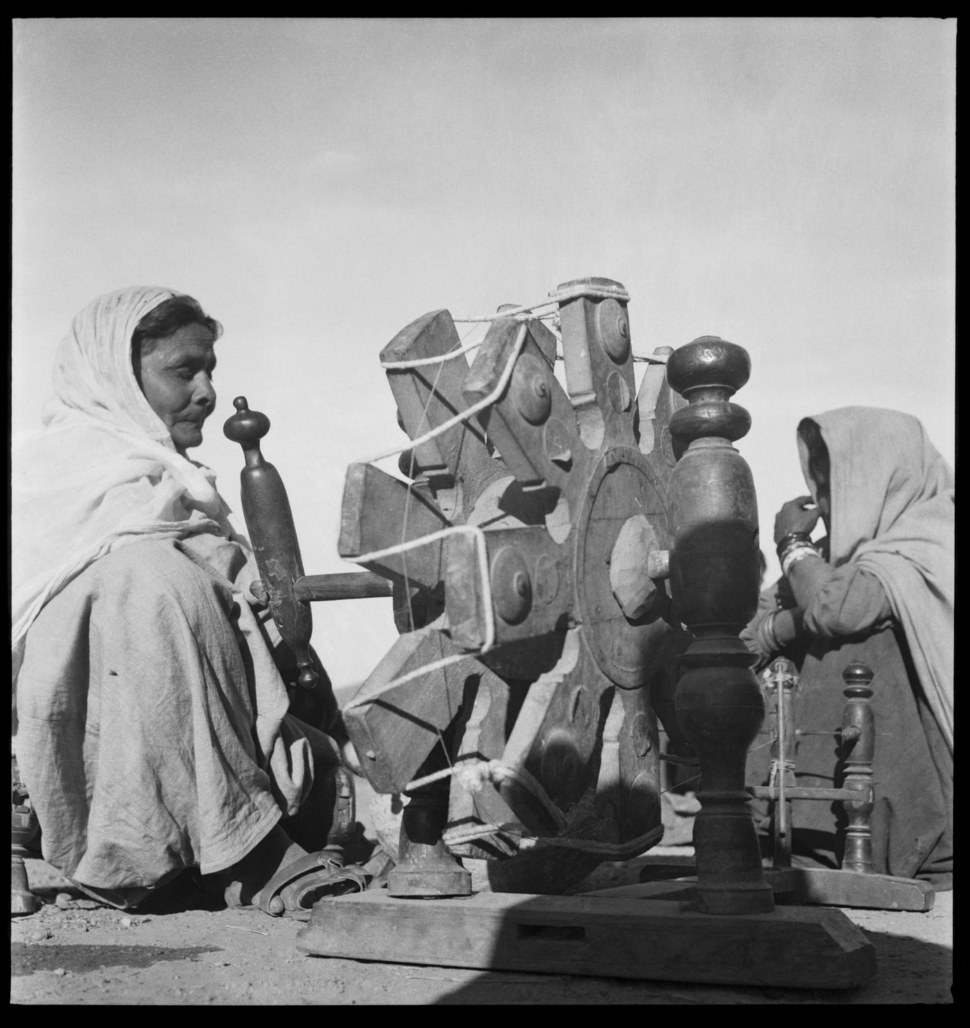 Unidenfied women working at a spinning wheel, India