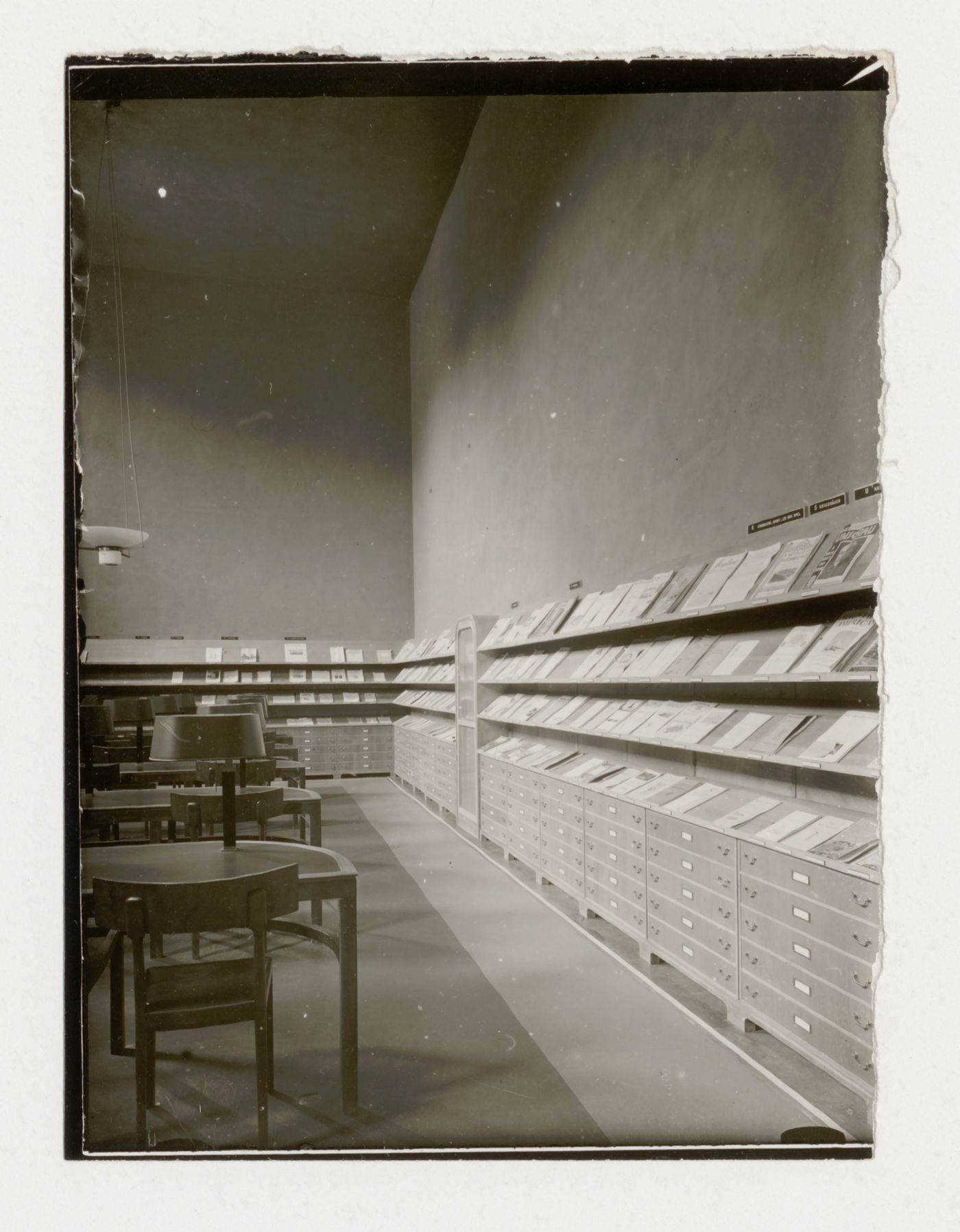 Interior view of the periodical room of Stockholm Public Library showing the racks for periodicals and filing cabinets, 51-55 Odengatan, Stockholm