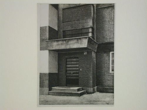Partial view of the block building "Sonnenhof" showing the entrance door and balcony, Berlin-Lichtenberg, Germany