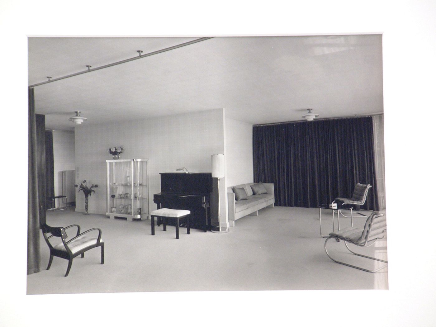 Interior, living room with piano, glass case, and tubular steel chairs, Germany