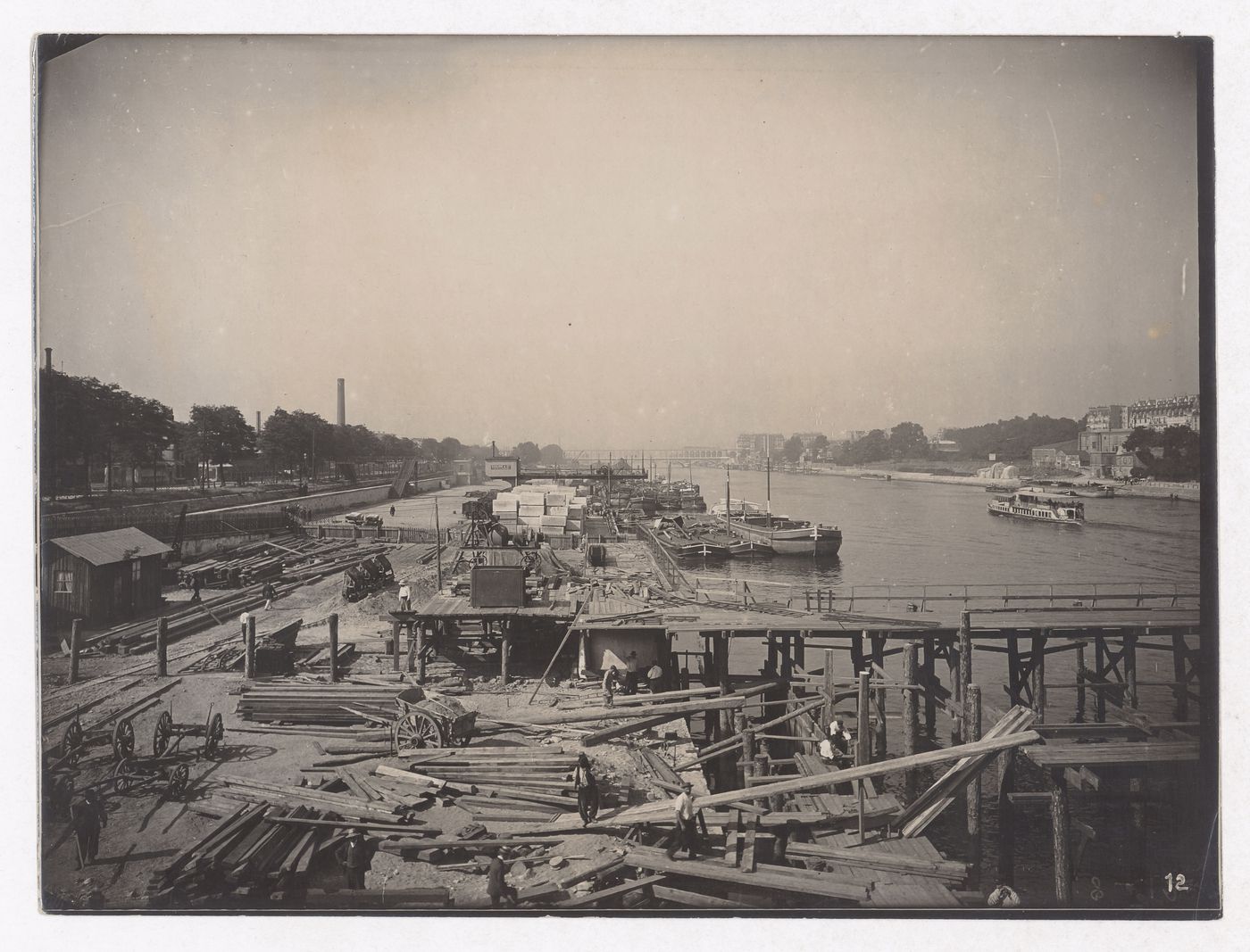 Construction of the Paris Metro, exterior view of construction site near the Seine and boats, Paris, France