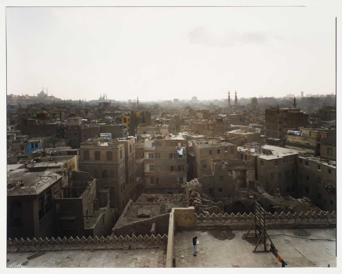 View of city from El Ashar, showing figure on roof directly below, Cairo, Egypt