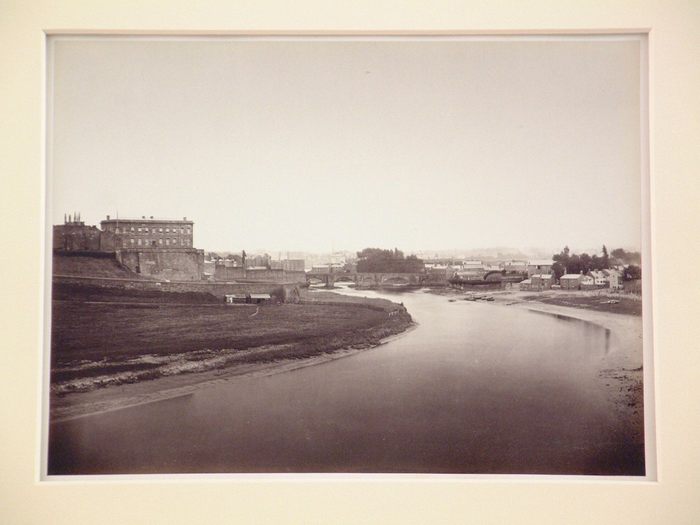 Distant view of Chester Castle, a bridge over the river Dee, and other buildings and houses, Chester, England