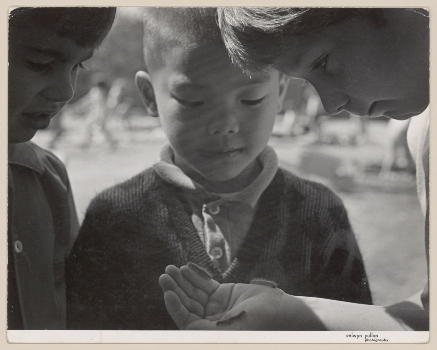 View of children absorbed in play in North Shore Neighbourhood House Playground, Vancouver, British Columbia