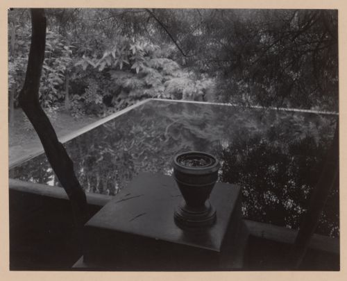 View of architect Otto Rothmayer's own garden showing urn next to water-filled basin reflecting surrounding foliage, Prague, Czechoslovakia