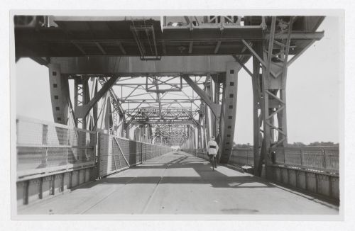 View of man riding a bicycle on the Blue Nile Road and Railway Bridge, Khartoum, Sudan