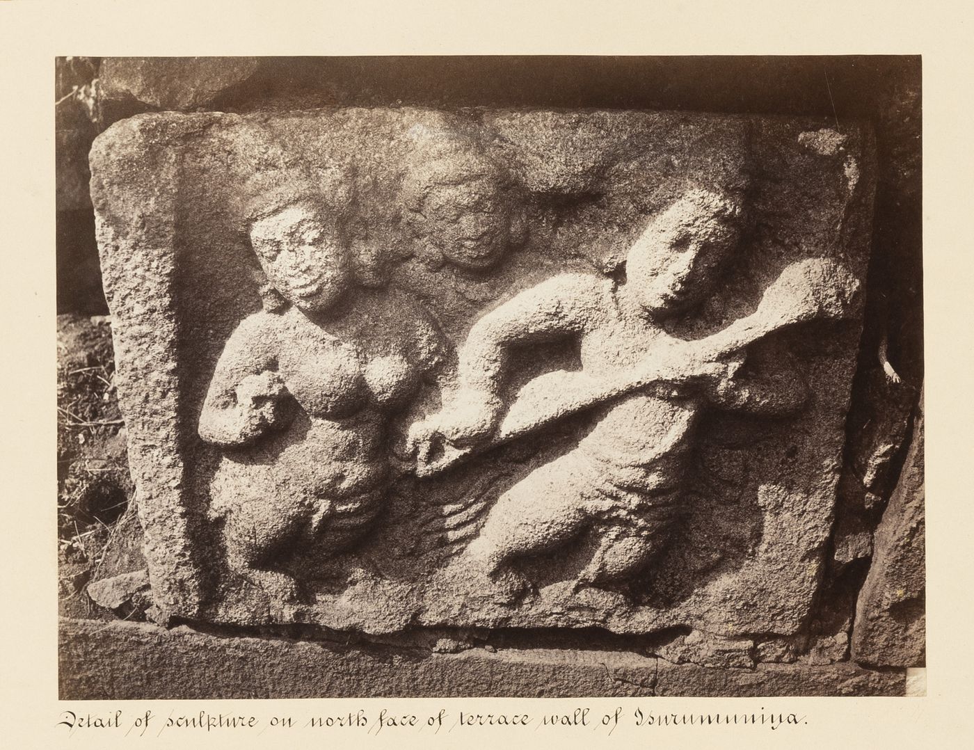 Close-up view of reliefs on the north façade of the terrace wall, Isurumuniya Temple, Anuradhapura, Ceylon (now Sri Lanka)