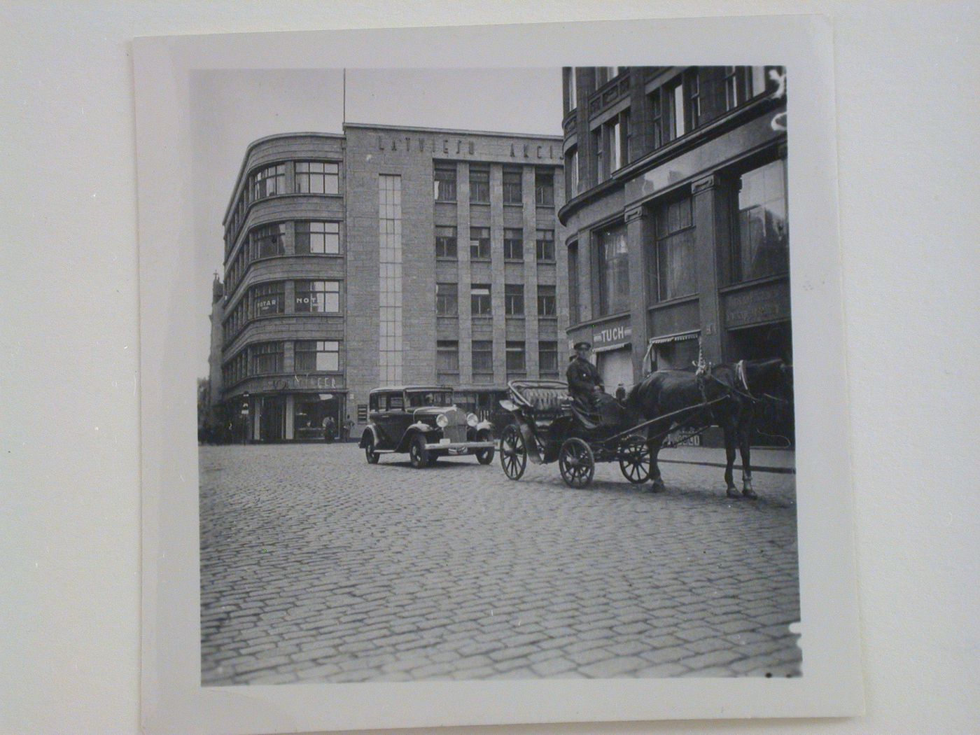 Exterior view of an unidentified multifunctional building showing stores