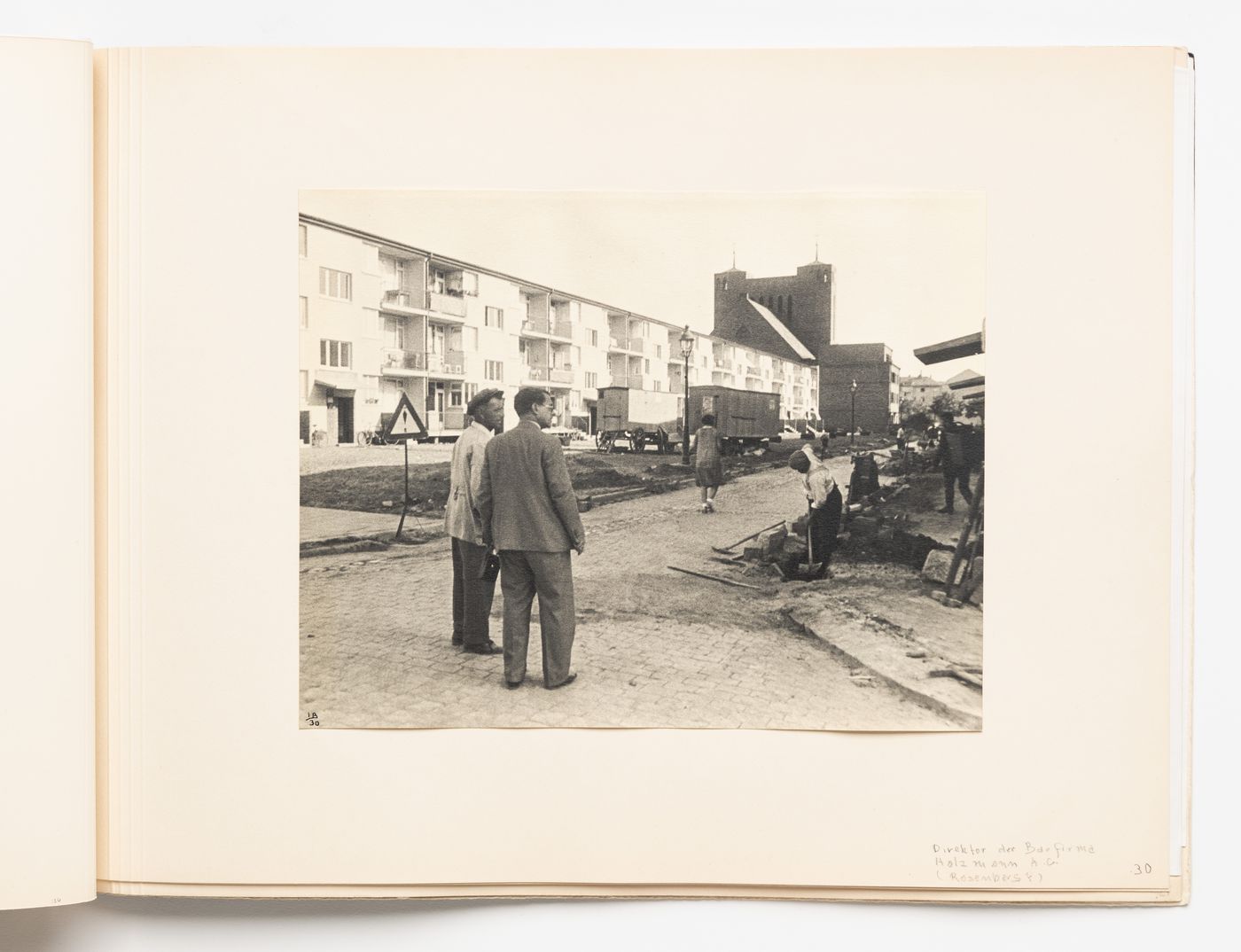 Exterior view of type A housing units with the Director of Holzmann A.G., Mr. Rosenberg [?], and a foreman [?], Hellerhof Housing Estate, Frankfurt am Main, Germany