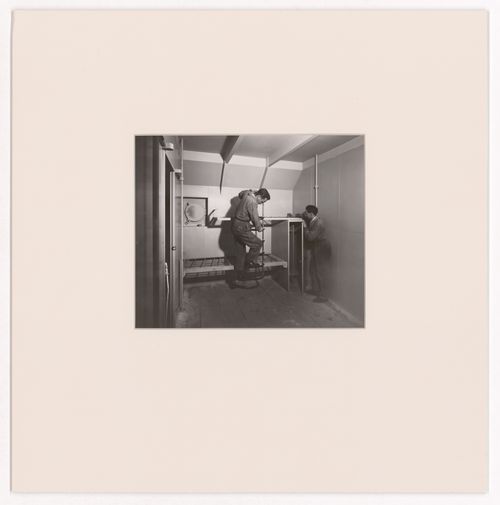 View of two men constructing an ocean liner cabin for the Otua, Salon d'automne, Paris, France