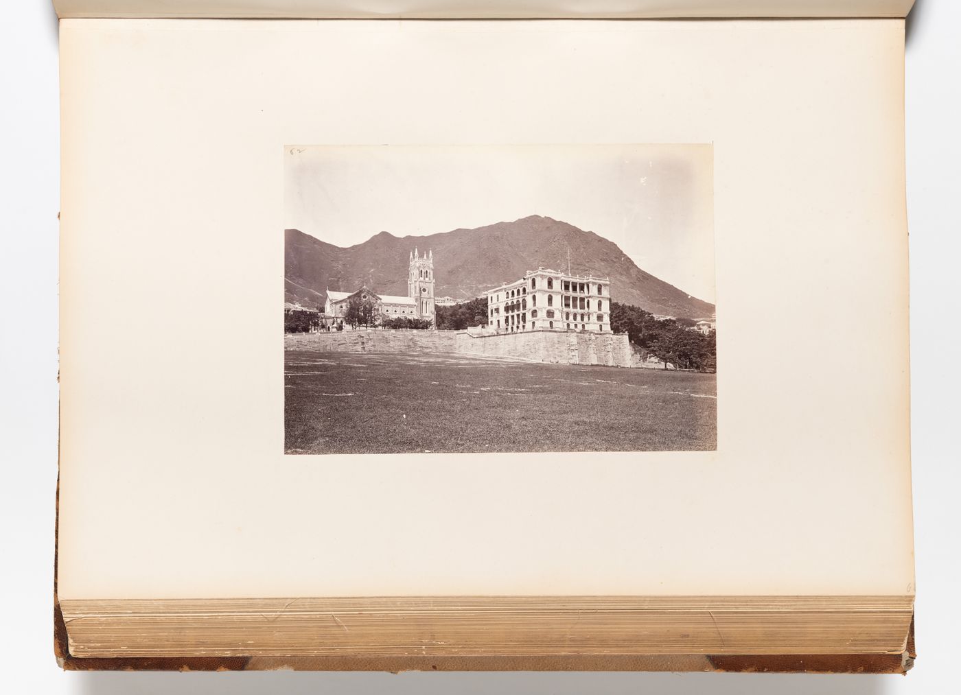 View of St. John's Cathedral and the premises of Augustine Heard & Co. showing the Parade Ground (also known as the Murray Parade Ground) in the foreground, Hong Kong (now Hong Kong, China)