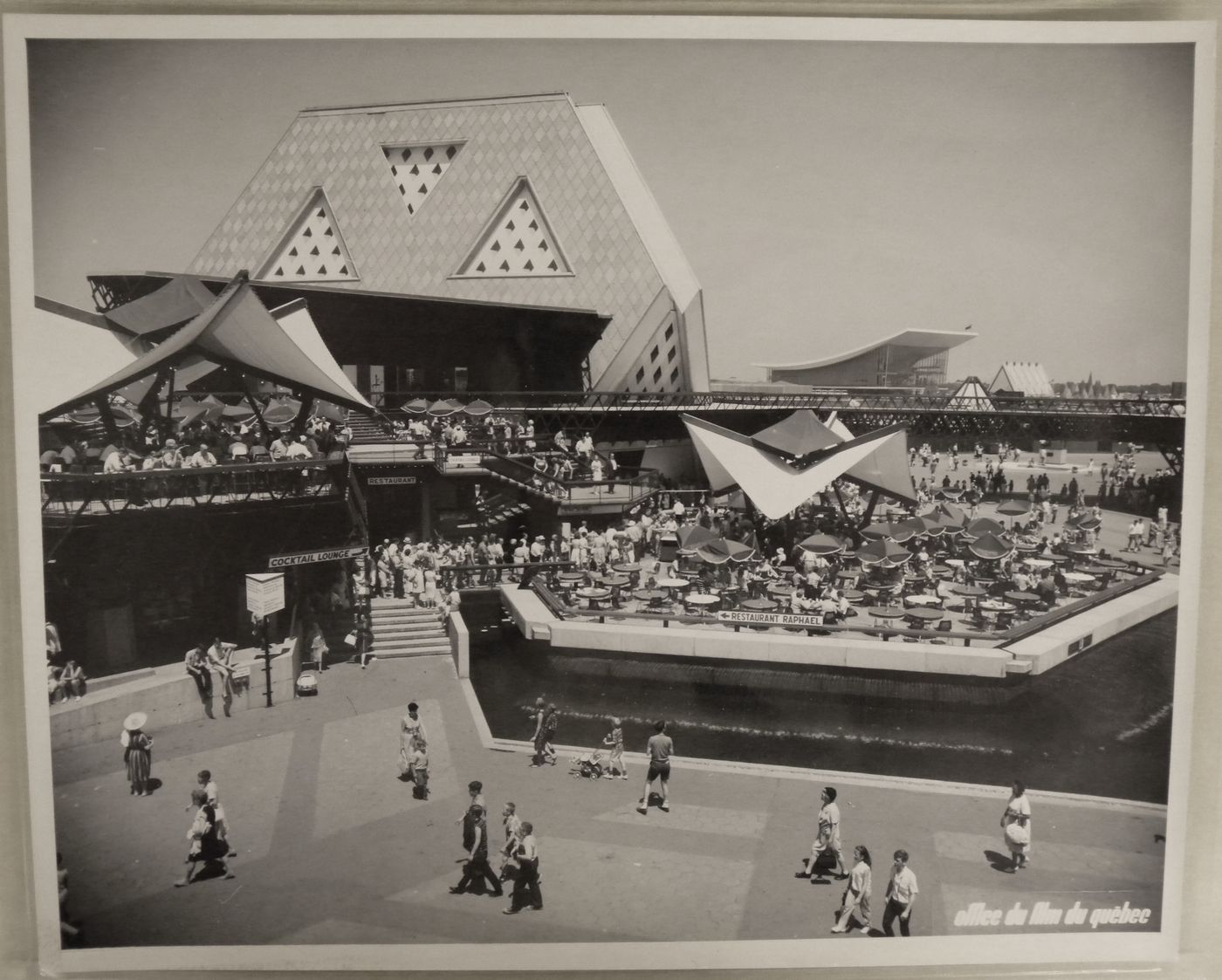 View of terraces at the Plaza of the Universe near the Man the Explorer Pavilion with the Pavilion of the Soviet Union in background, Expo 67, Montréal, Québec