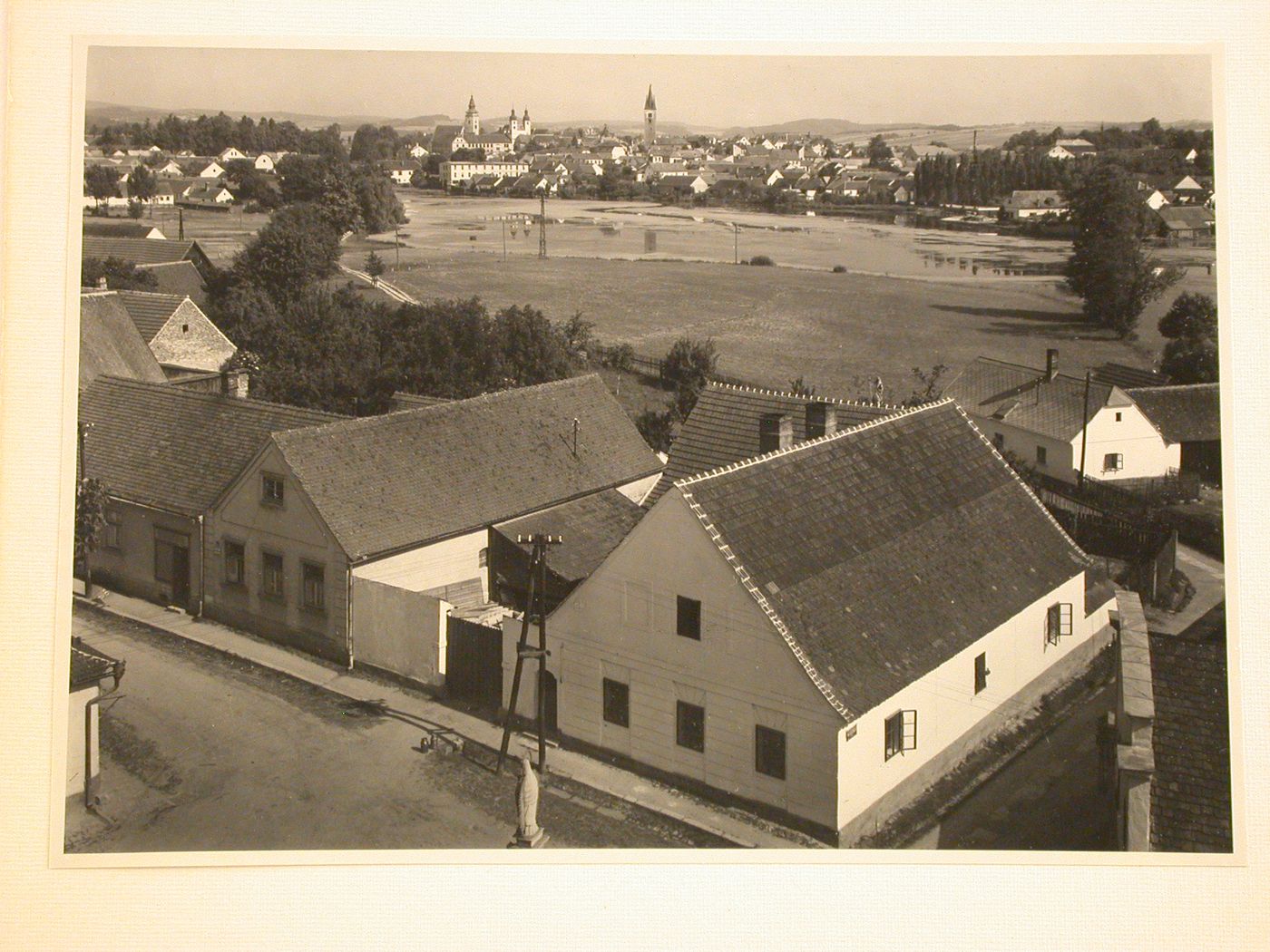 View from across Staromestský Pond and showing the towers of St. James Church, the Church of Jesus' Name and the Church of the Holy Spirit, Telc, Czechoslovakia (now Czech Republic)