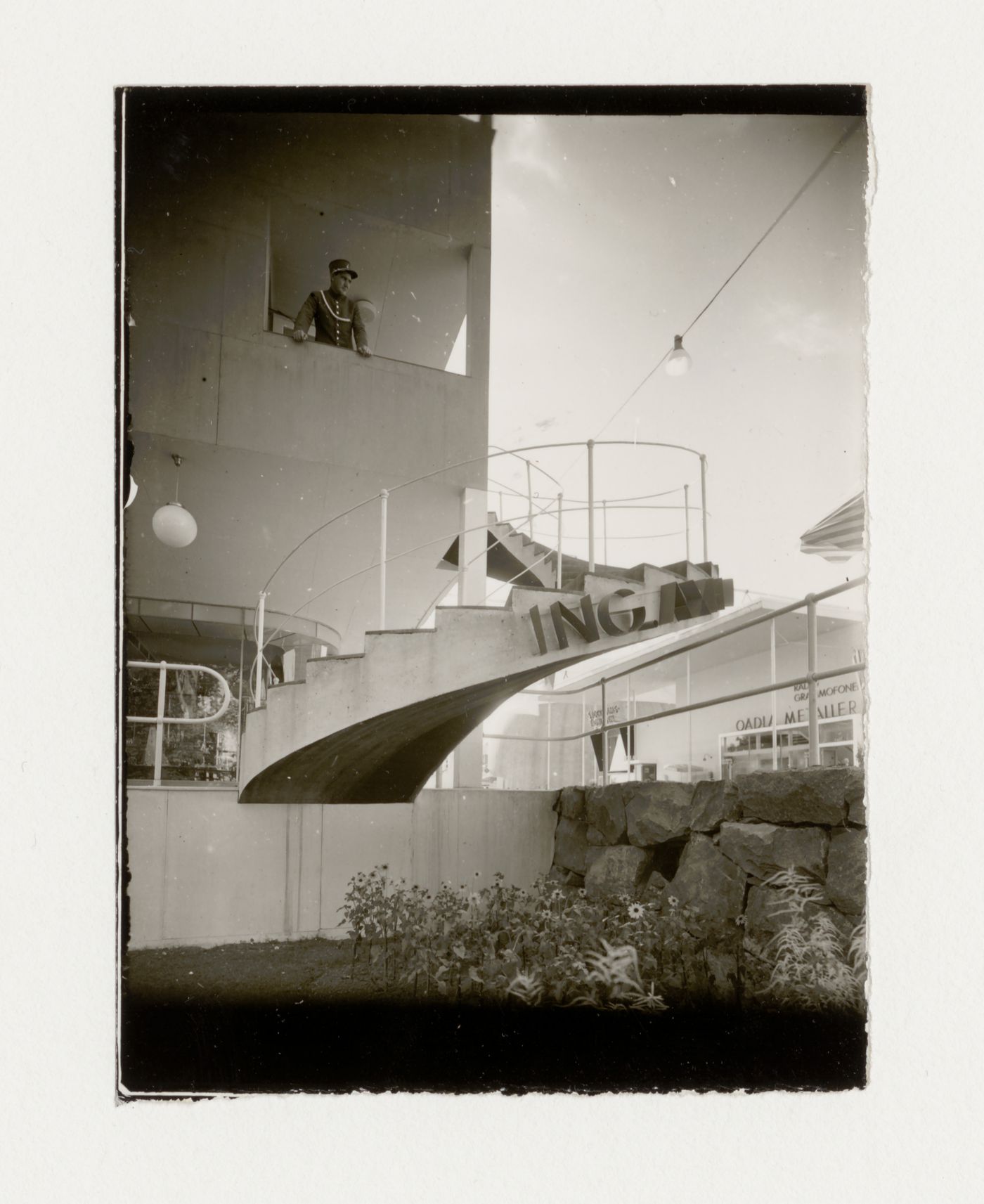 Exterior view of halls 8 and 9 at the Stockholm Exhibition of 1930 showing the stairs with a man standing on the landing, Stockholm
