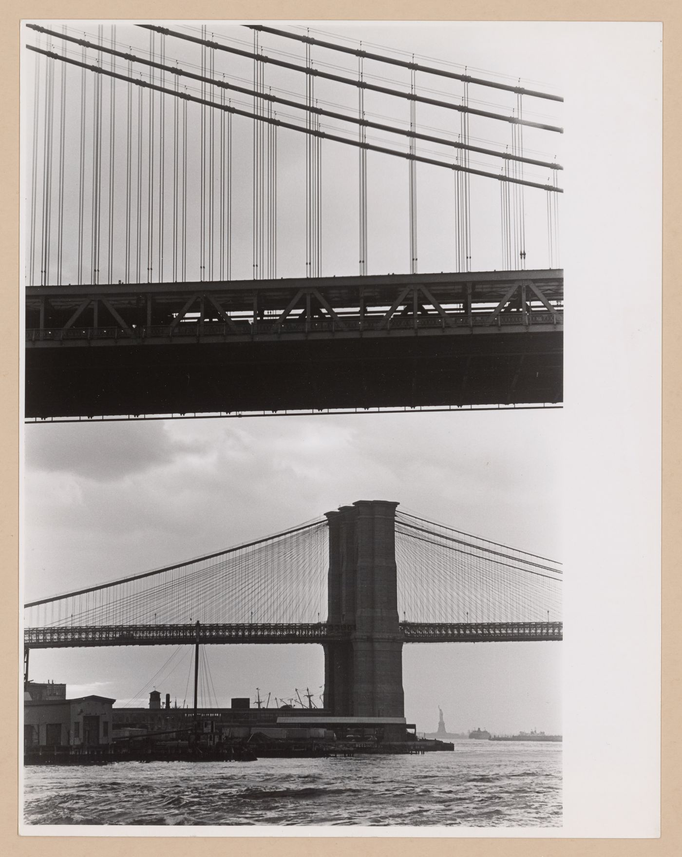 Partial views of the Manhattan and Brooklyn bridges with the Statue of Liberty in the background, New York City, New York