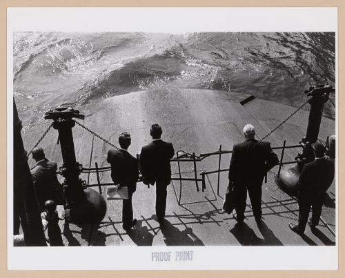 View of men standing on the deck of the Hoboken Ferry looking at the water