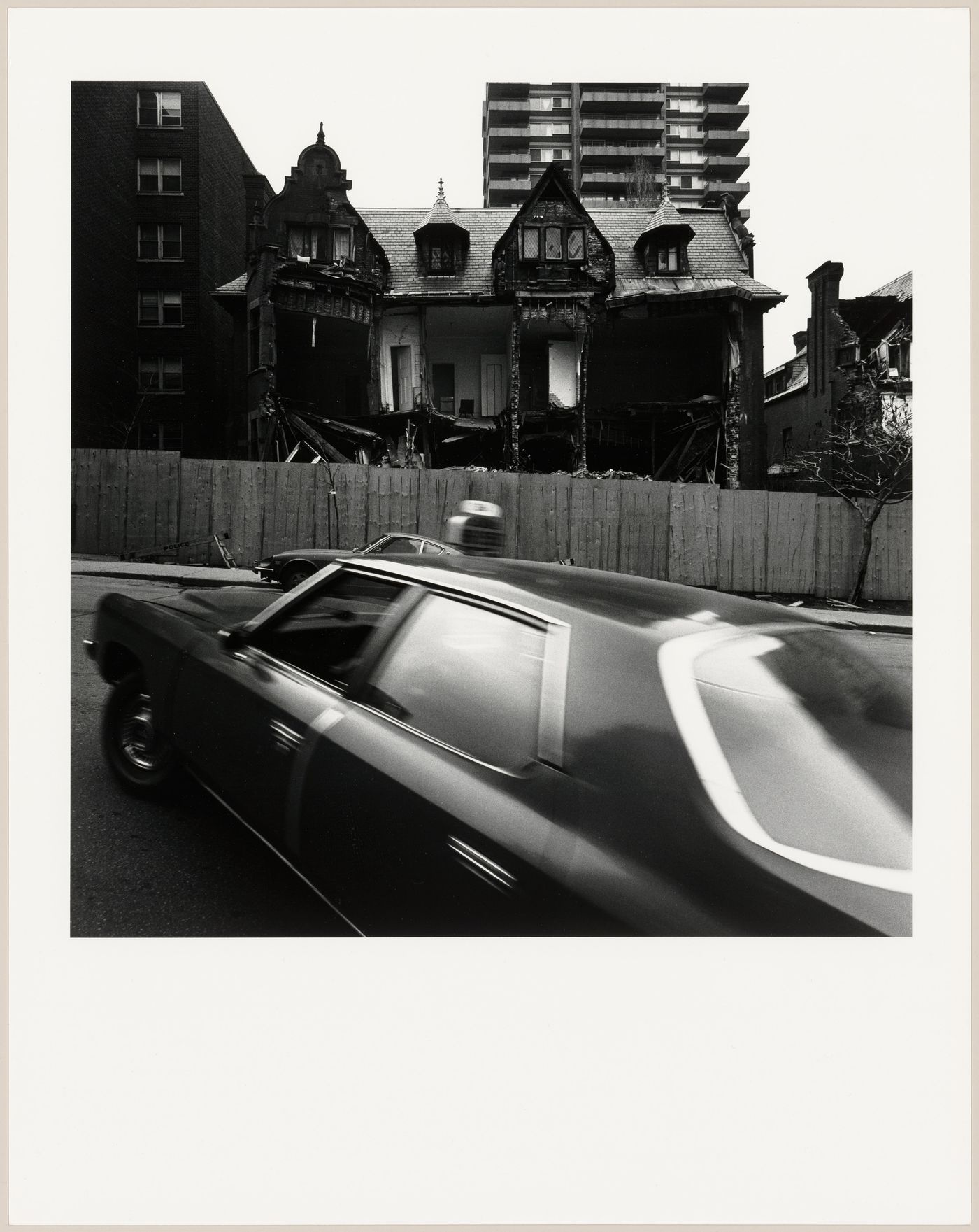View of a partially demolished semidetached house, rue Drummond, Montréal, Québec