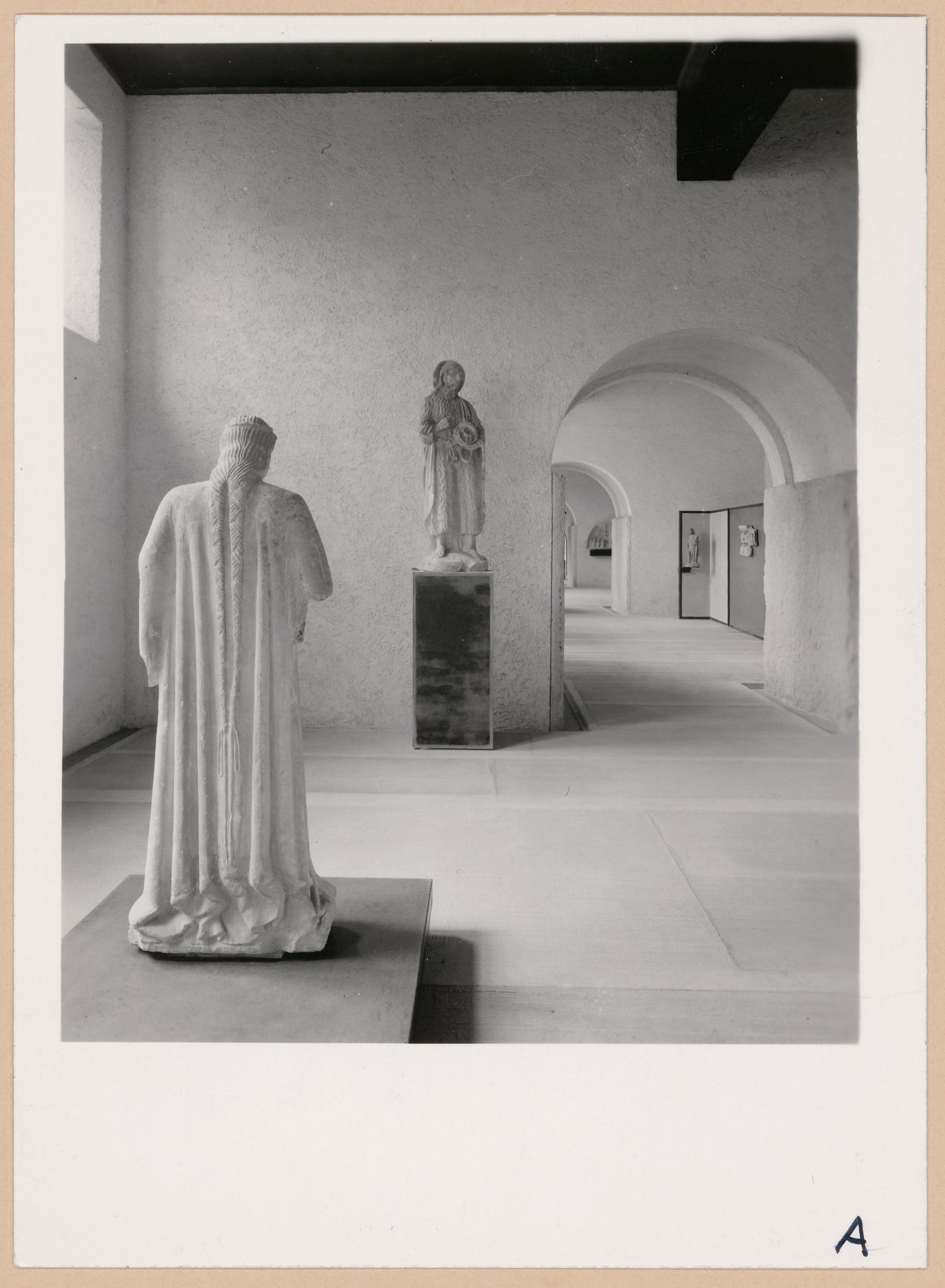 Interior view of a gallery showing statues with doorways and other galleries in the right background, Museo di Castelvecchio, Verona, Italy