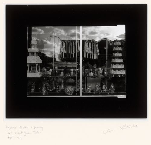 View of a display window of Kapatos Pastry & Bakery showing wedding cakes, confectioneries [?] and the reflection of apartment houses [?] across the street, 750 rue Jean-Talon Ouest, Montréal, Québec