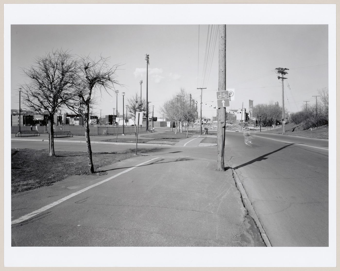 View of the bicycle path looking east along côte St. Paul with Centre Gadbois Park and the entry to Lock no. 4 in the background, Montréal, Québec