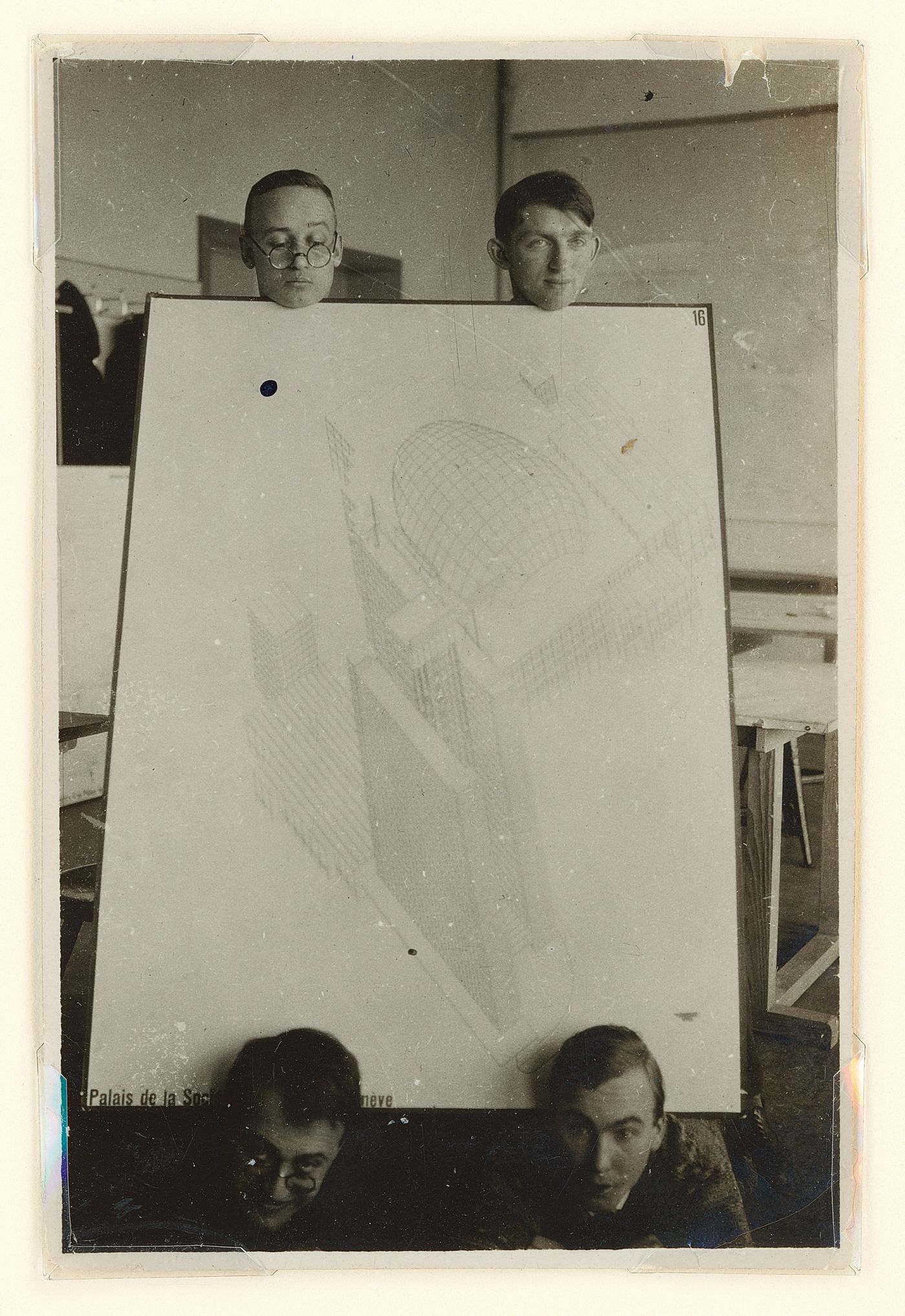 Portrait of Hannes Meyer, Aryeh Sharon and unidentified students at the Bauhaus in Dessau, Germany, holding a competition drawing by Hannes Meyer and Hans Wittwer for the League of Nations Building in Geneva, Switzerland