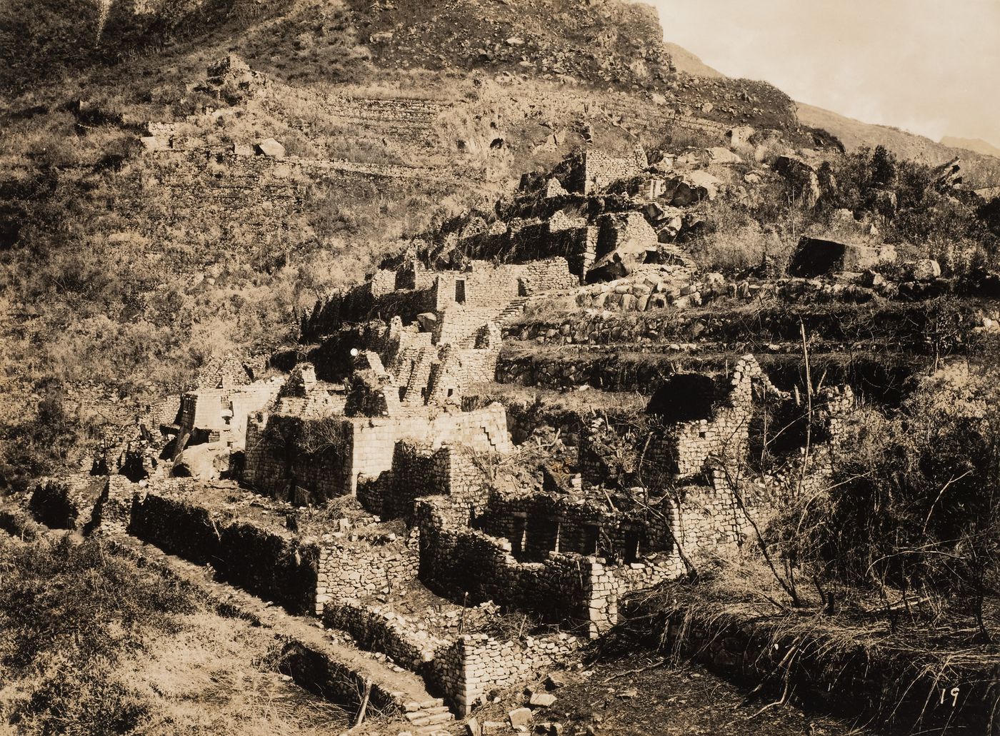View of Machu Picchu from the Industrial Sector showing the King's Group, Serpent Gate and Torreón in the distance, Peru