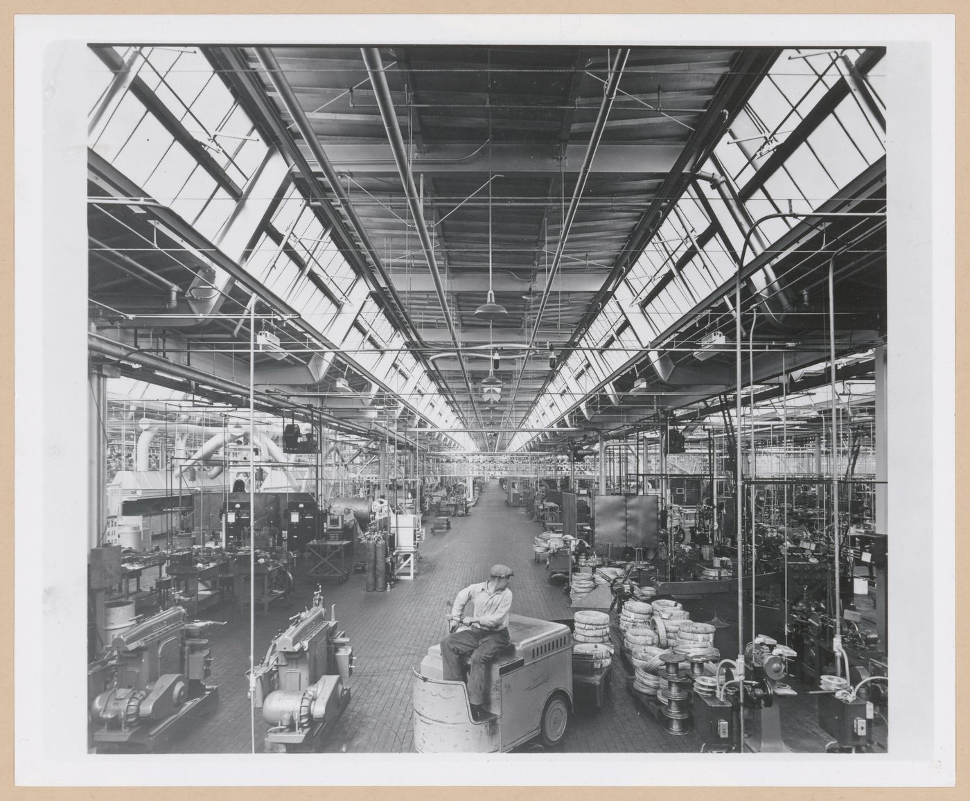 Interior view of the Manufacturing Building showing a worker using a forklift [?], General Motors Corporation Delco Appliance division Assembly Plant, Rochester, New York