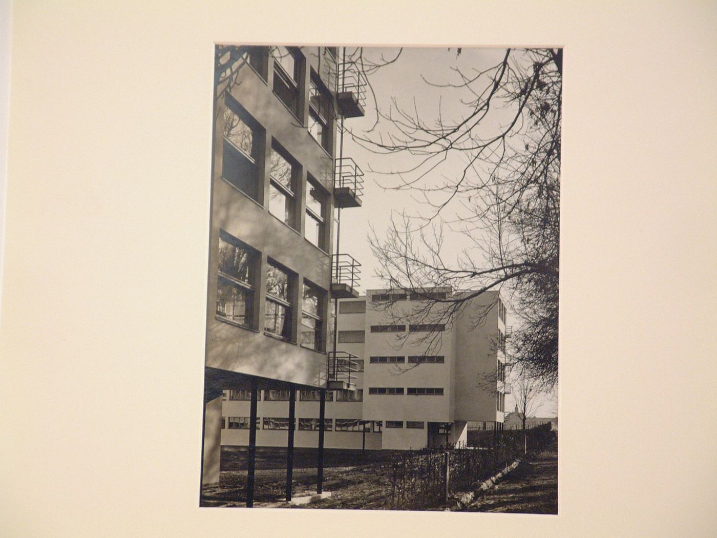 Detail of exteriors of two five-story, stucco-clad modern buildings with balconies